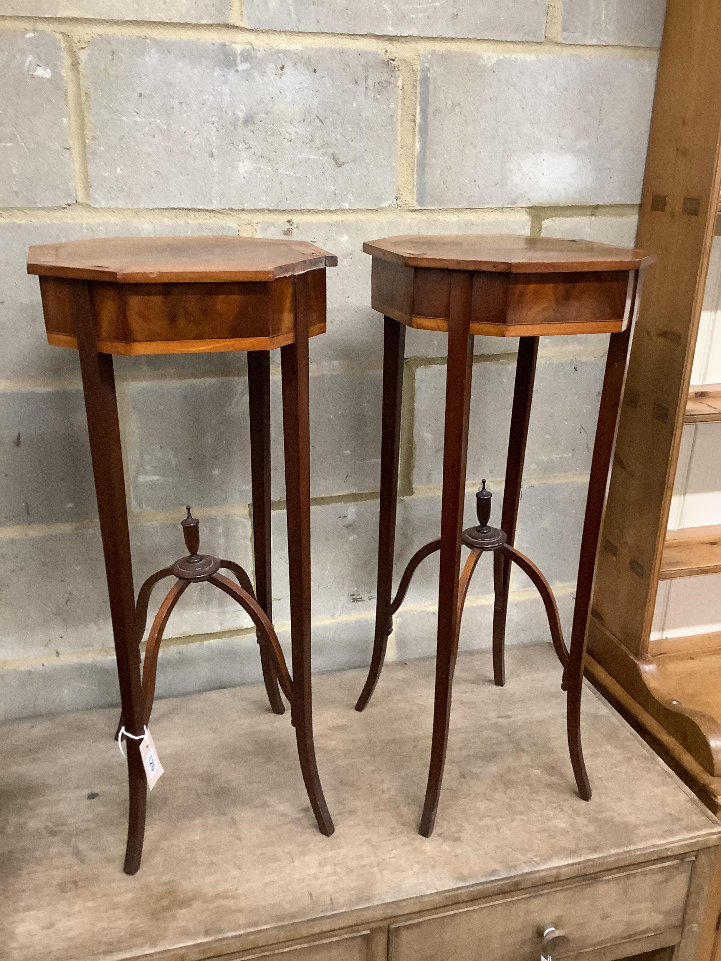 A pair of Sheraton style octagonal inlaid mahogany urn stands, width 33cm, height 75cm